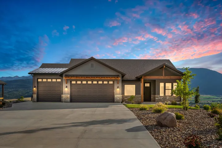 Exterior featuring stone accents, horizontal siding, and a shingled roof