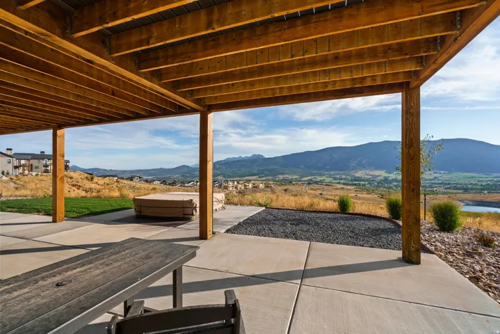 Expansive covered patio with exposed wood beams and structural columns
