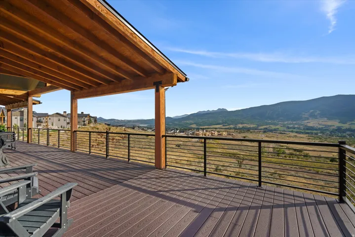 Expansive covered deck with composite decking, natural wood ceiling, and a cable railing system