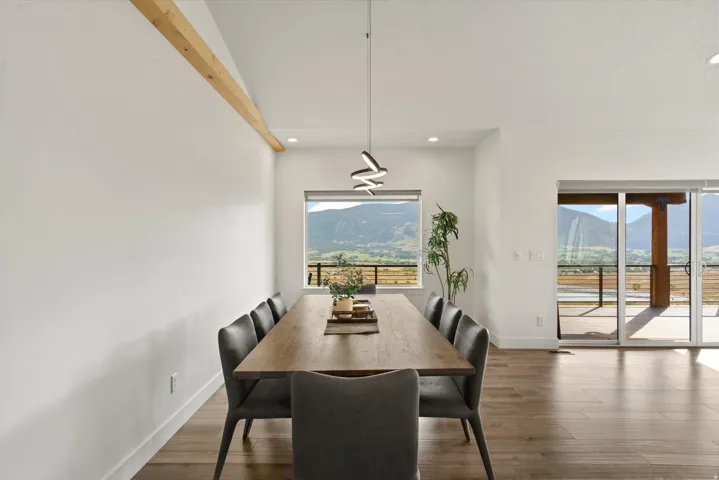Expansive interior with a vaulted ceiling and exposed wood beam