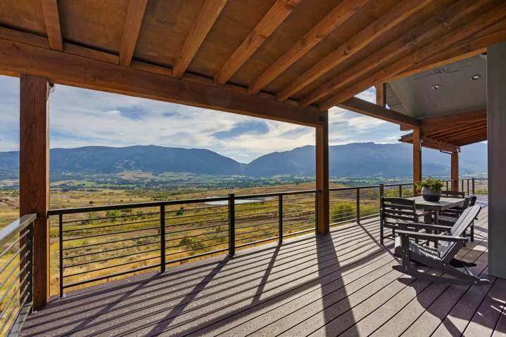 Expansive covered deck featuring wood beam construction and composite decking