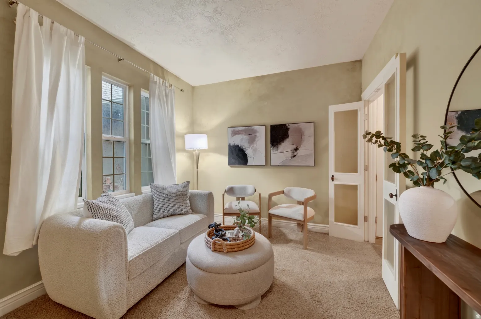 Multiple pane windows with natural light, neutral wall colors, and carpeted flooring