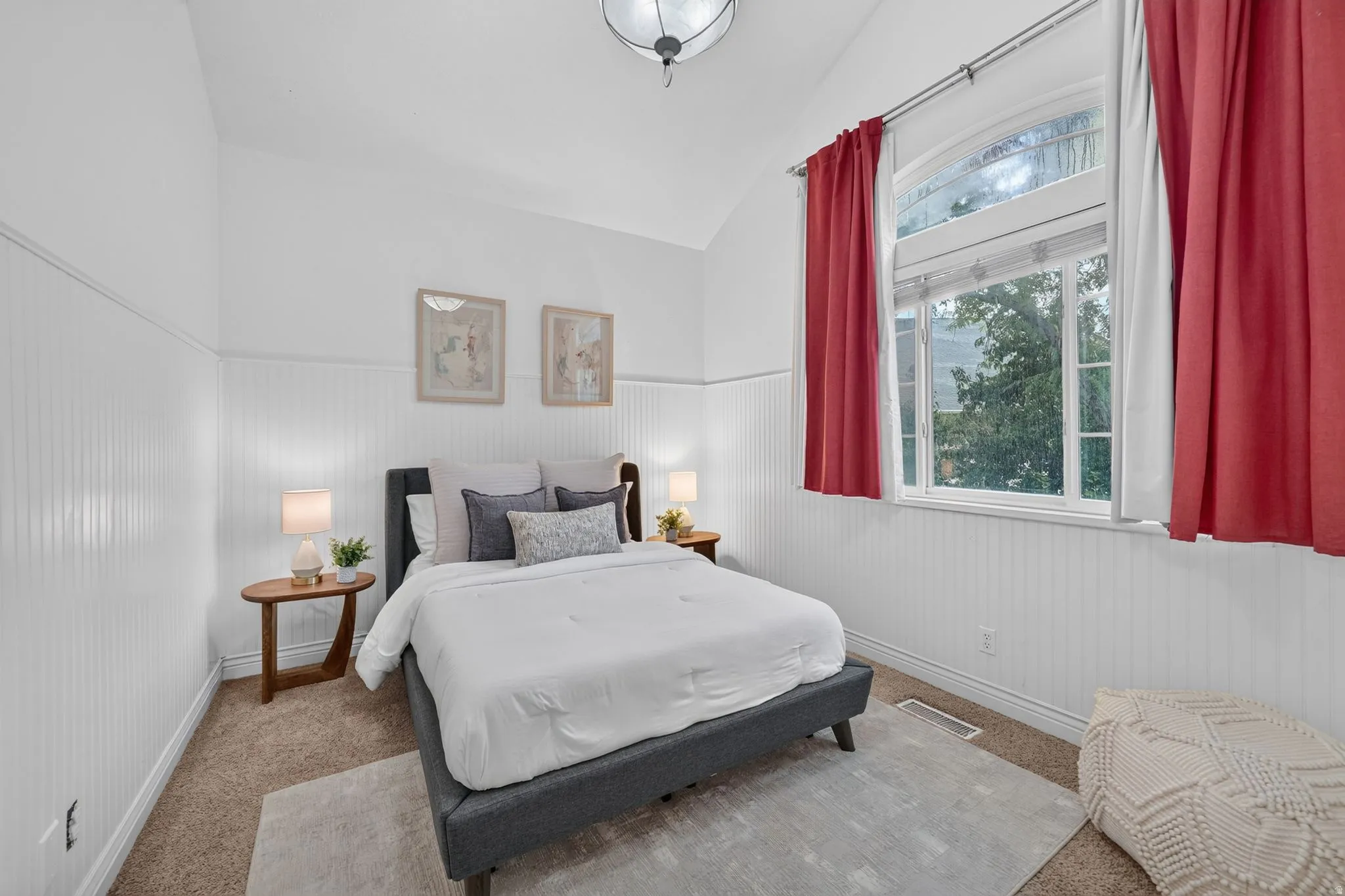 Vaulted ceiling accentuates the spaciousness, complemented by beadboard wall paneling