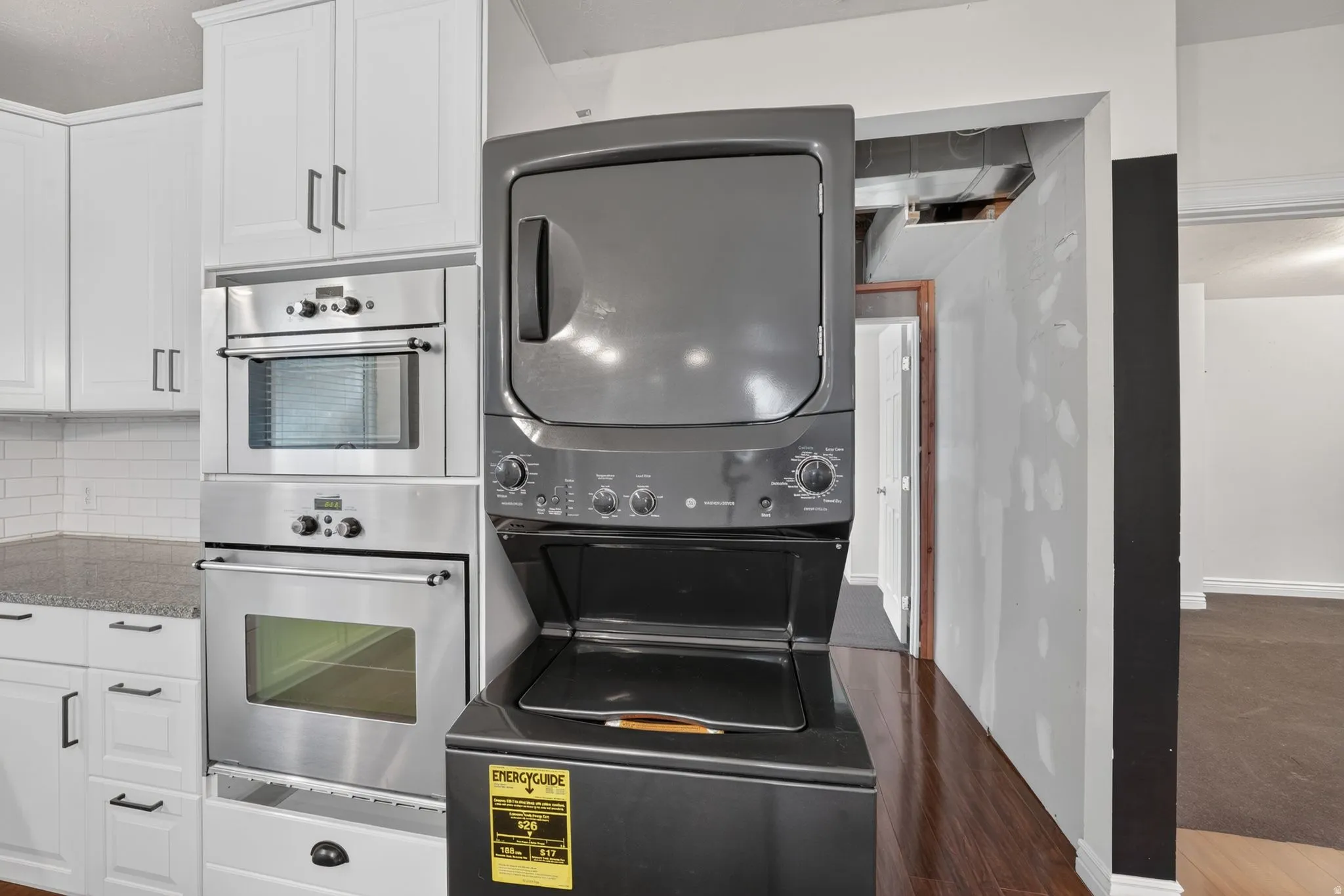 White shaker-style cabinetry with stainless steel appliances, including a built-in microwave and oven