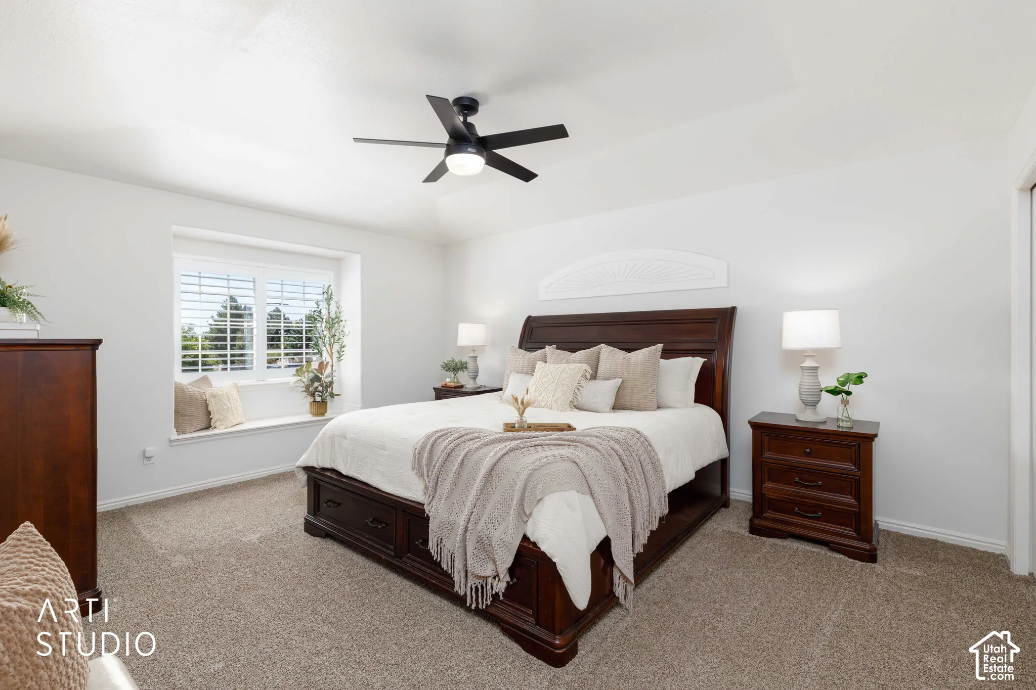 Bedroom #3 (Primary) Includes a recessed window with white plantation shutters, white plantation black out fan over half moon shaped Window located over bed.