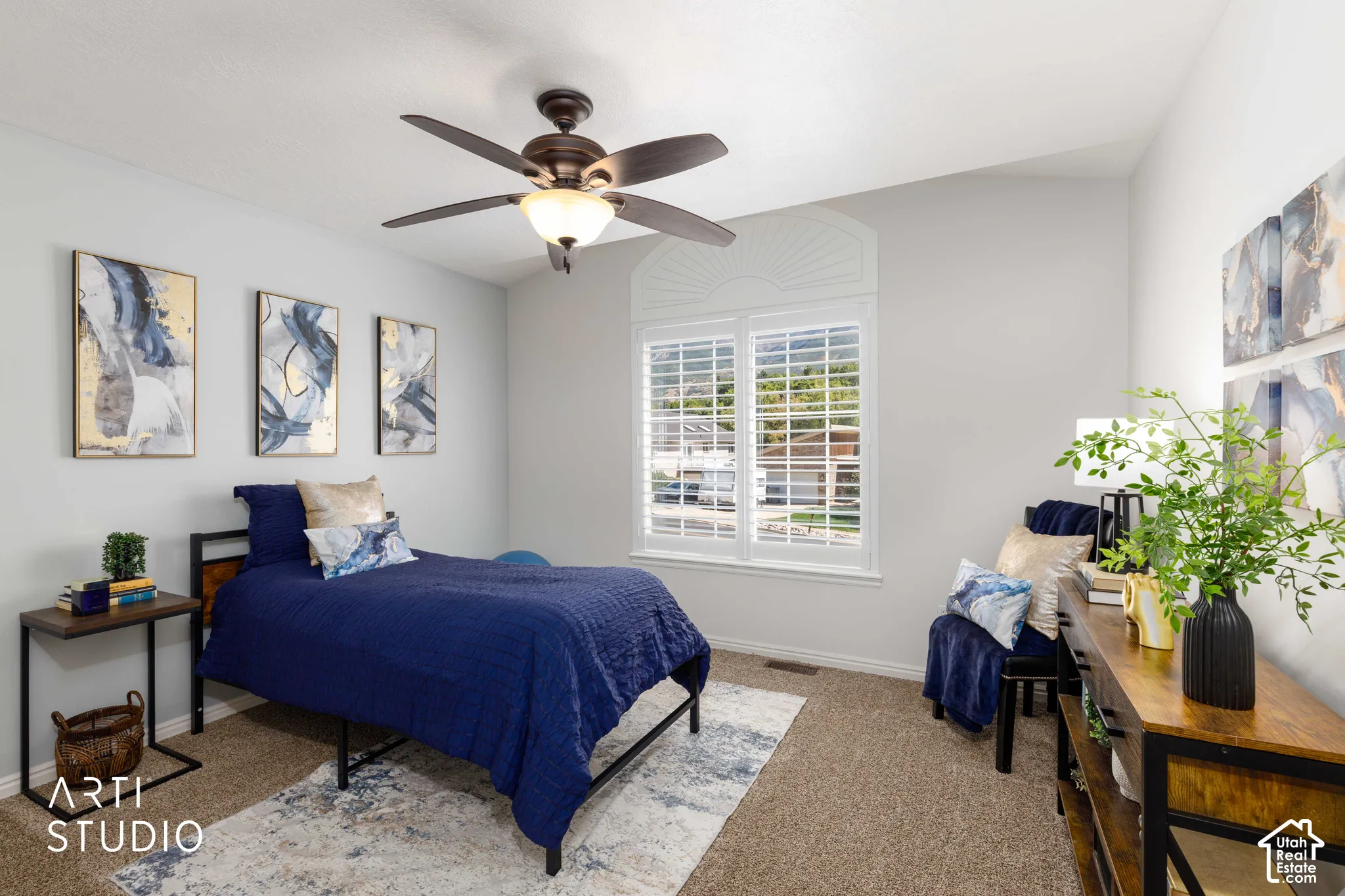 Bedroom #1 Ceiling fan with integrated light, window with decorative fanlight, plantation shutters, and light gray wall paint and new tan carpet.