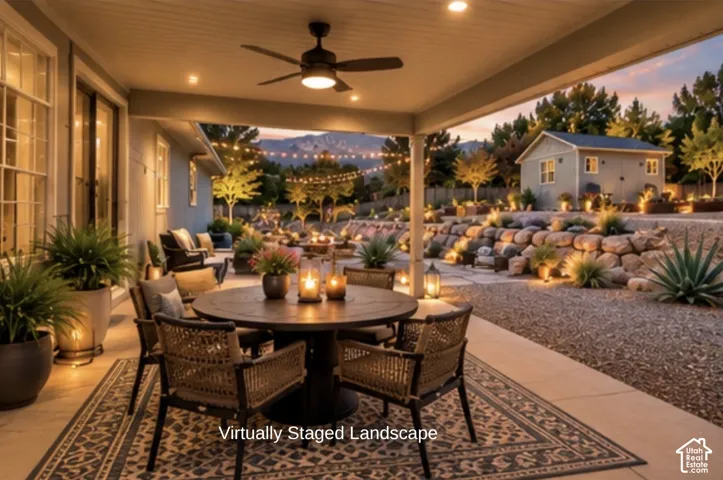 Covered concrete patio featuring a ceiling fan, recessed lighting, terraced stone retaining walls, and a detached outbuilding - Virtural landscape/staged patio- Not Existing