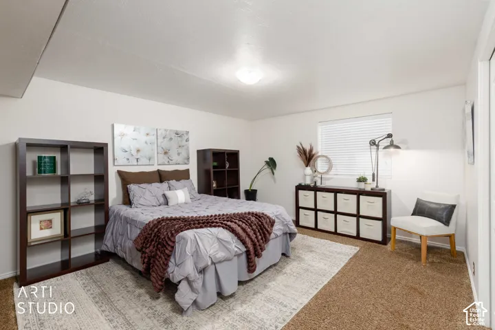 Bedroom #5 Large room with brown accent wall, bifold closet doors, brown carpet and window with white blinds