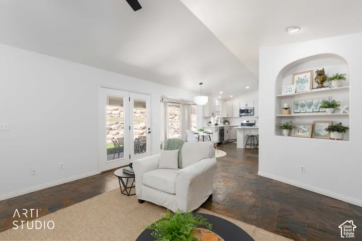 Recessed archway shelving, French doors, multi-toned slate flooring, and a modern overhead light fixture