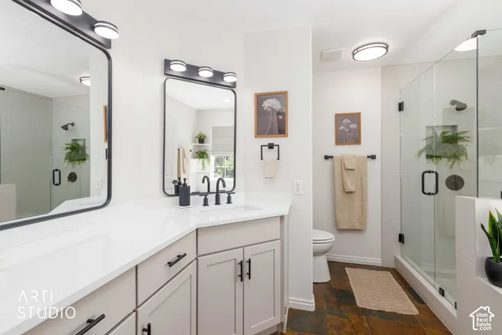 Primary bath with new  Buff vanity, white quartz countertop and integrated undercount sink, featuring new matte black mirrors, lighting and fixtures throughout. Multi-toned slate flooring
