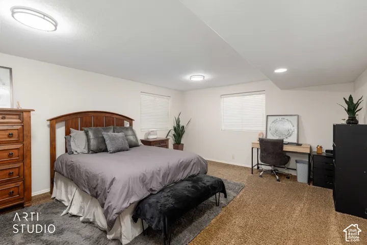 Bedroom #4 Large room with Neutral wall finishes , updated flush mount lighting, brown carpet and two windows with white blinds and recessed lighting