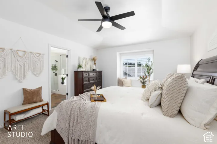 Entry to primary bathroom from large bedroom with  a ceiling fan with light fixture (w/remote).