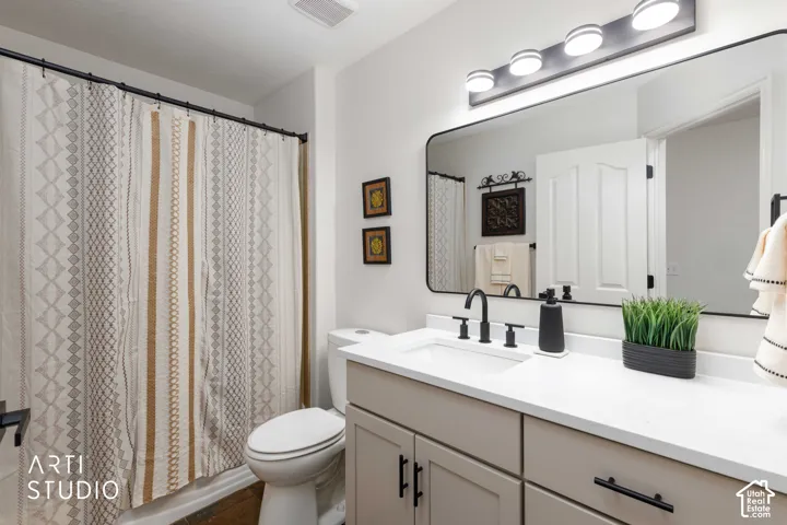 Main hall bathroom with new Buff vanity with shaker style cabinetry, white quartz countertop, rectangular undermount sink, and matte black fixtures and Mirror multi-toned slate flooring.
