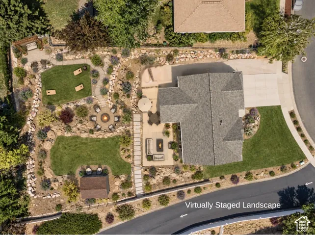 Aerial perspective featuring a multi-tiered backyard with stone retaining walls, manicured lawn areas, a concrete patio, a flagstone pathway, and a built-in fire pit- Virtural landscape- Not Existing