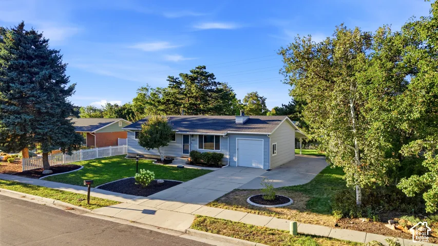 Light blue exterior with a gray roof and attached garage