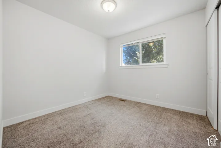 Neutral-toned carpeting complements the light wall color