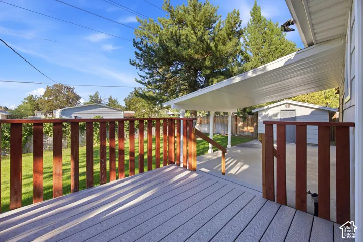Deck featuring composite flooring and wood railings