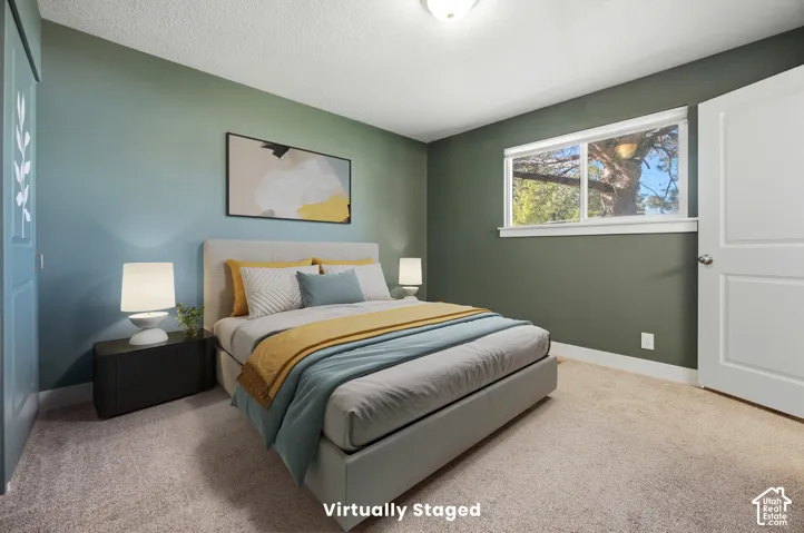 Carpeted flooring paired with a window featuring exterior scenery