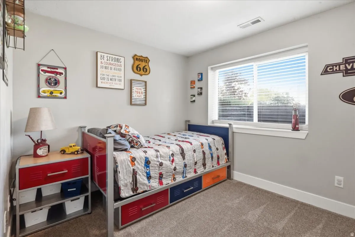 Carpeted flooring, neutral wall color, single window with blinds, recessed lighting