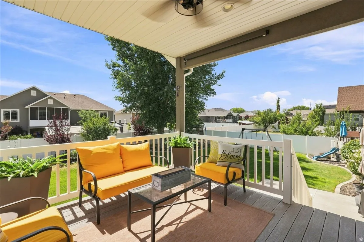 Covered composite deck with a ceiling fan, recessed lighting, and white railings