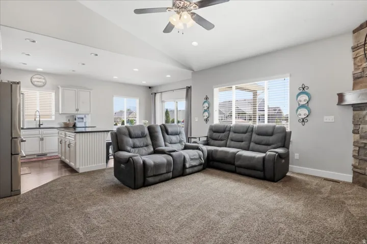 Open-concept living space with vaulted ceilings and recessed lighting