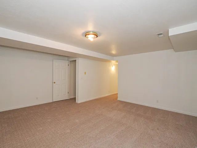 Wall-to-wall carpeting and white walls with white trim