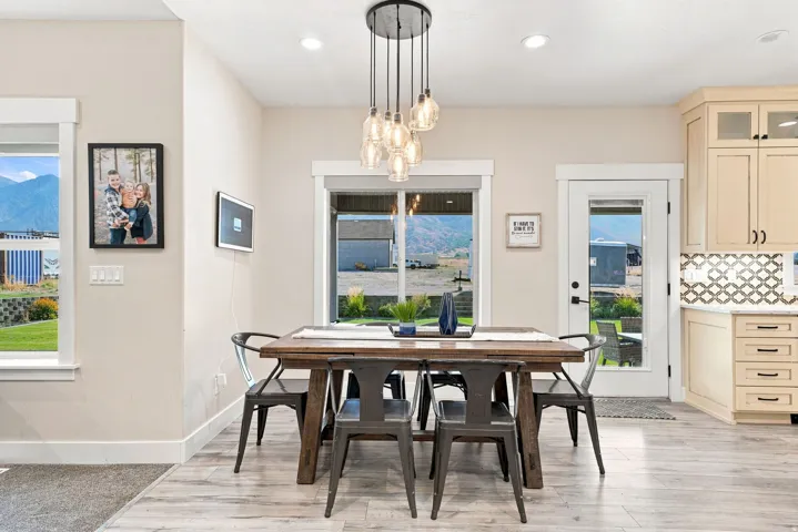 Open-concept dining area with wood-finish flooring