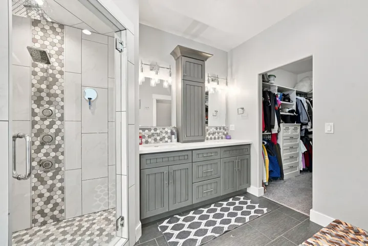 Frameless glass shower with multi-head system and hex tile accents
