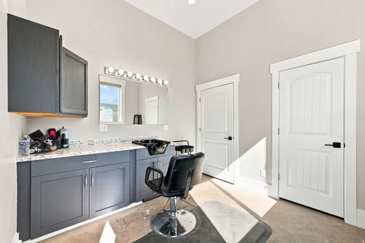 Custom vanity with gray cabinetry and light-toned countertop
