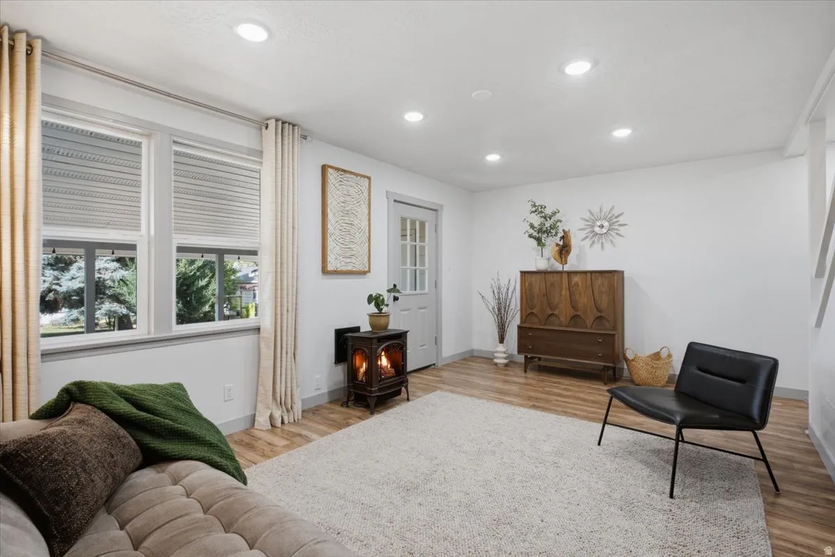 Recessed lighting illuminates the laminate wood-finish flooring