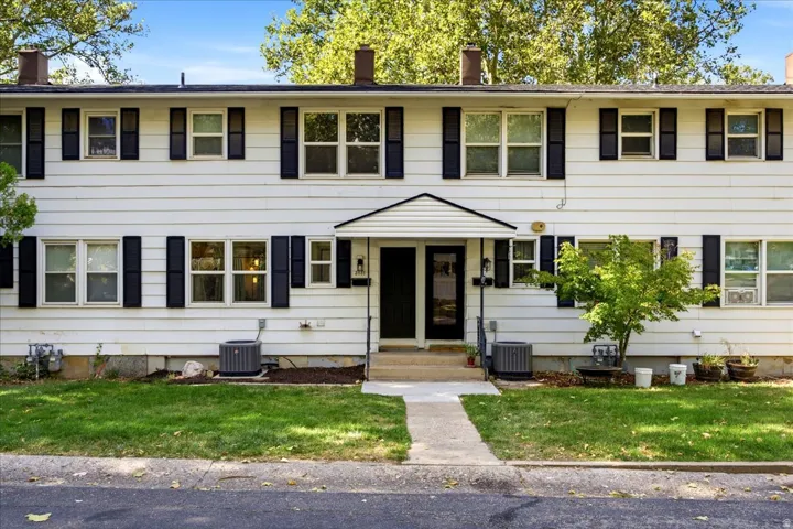 White exterior siding with dark window shutters