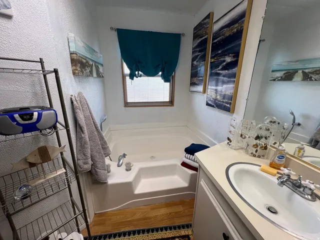 Primary bathroom with separate tub and shower, double sinks