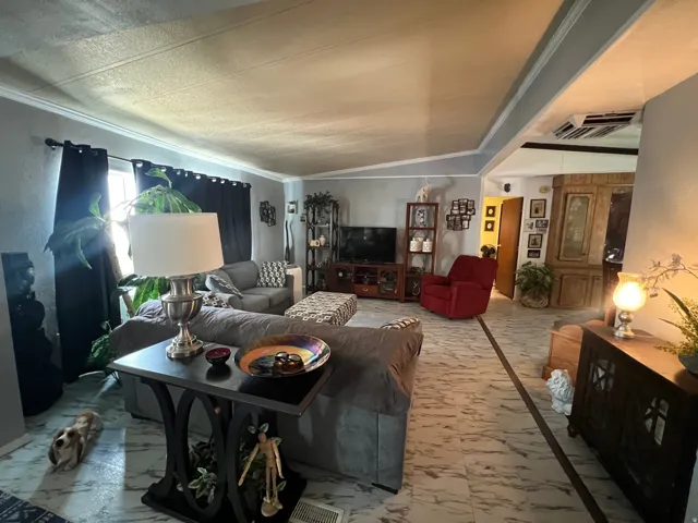White and gray patterned flooring, crown molding, and recessed ceiling panels