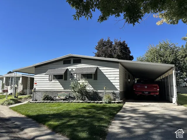 White horizontal siding exterior with a dark gray shingled roof