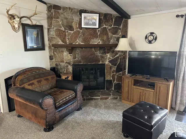 Stone-clad fireplace with wood mantel and hearth
