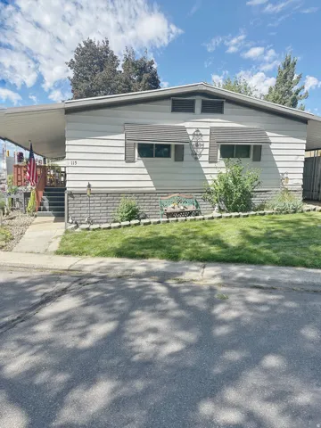 Siding exterior with decorative awnings and a covered entry