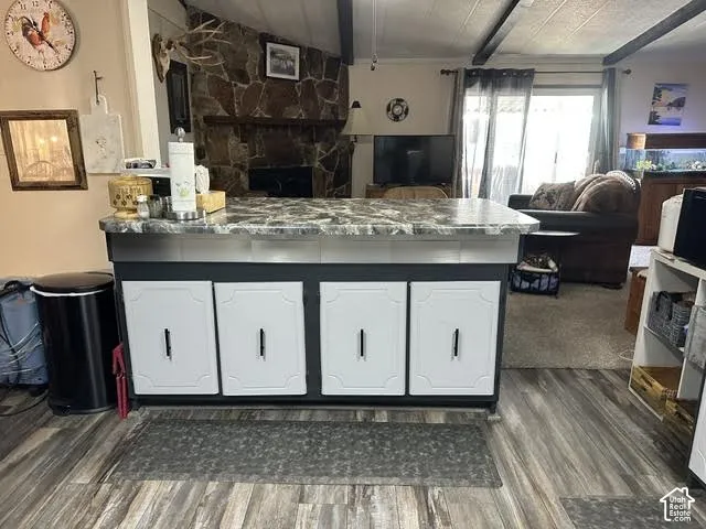 Kitchen island with a stone-finish countertop and built-in cabinetry