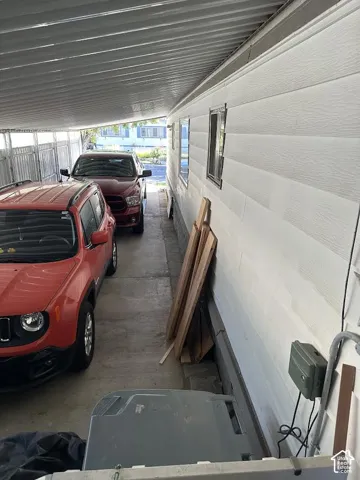 Covered carport with a concrete drive