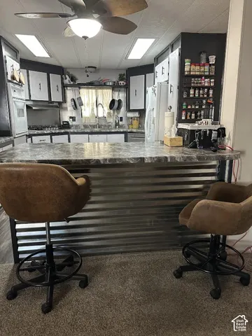 Kitchen island with a corrugated metal base and a stone-finish countertop