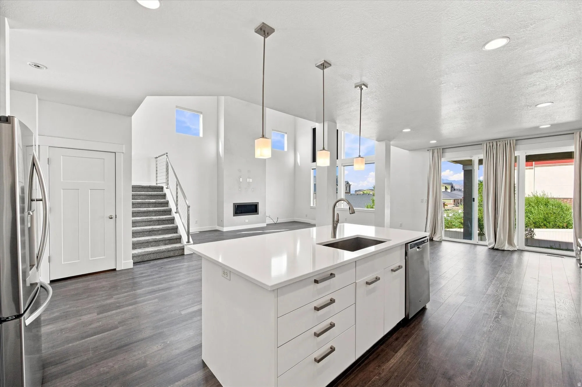 Open-concept living area with dark wood-finish flooring