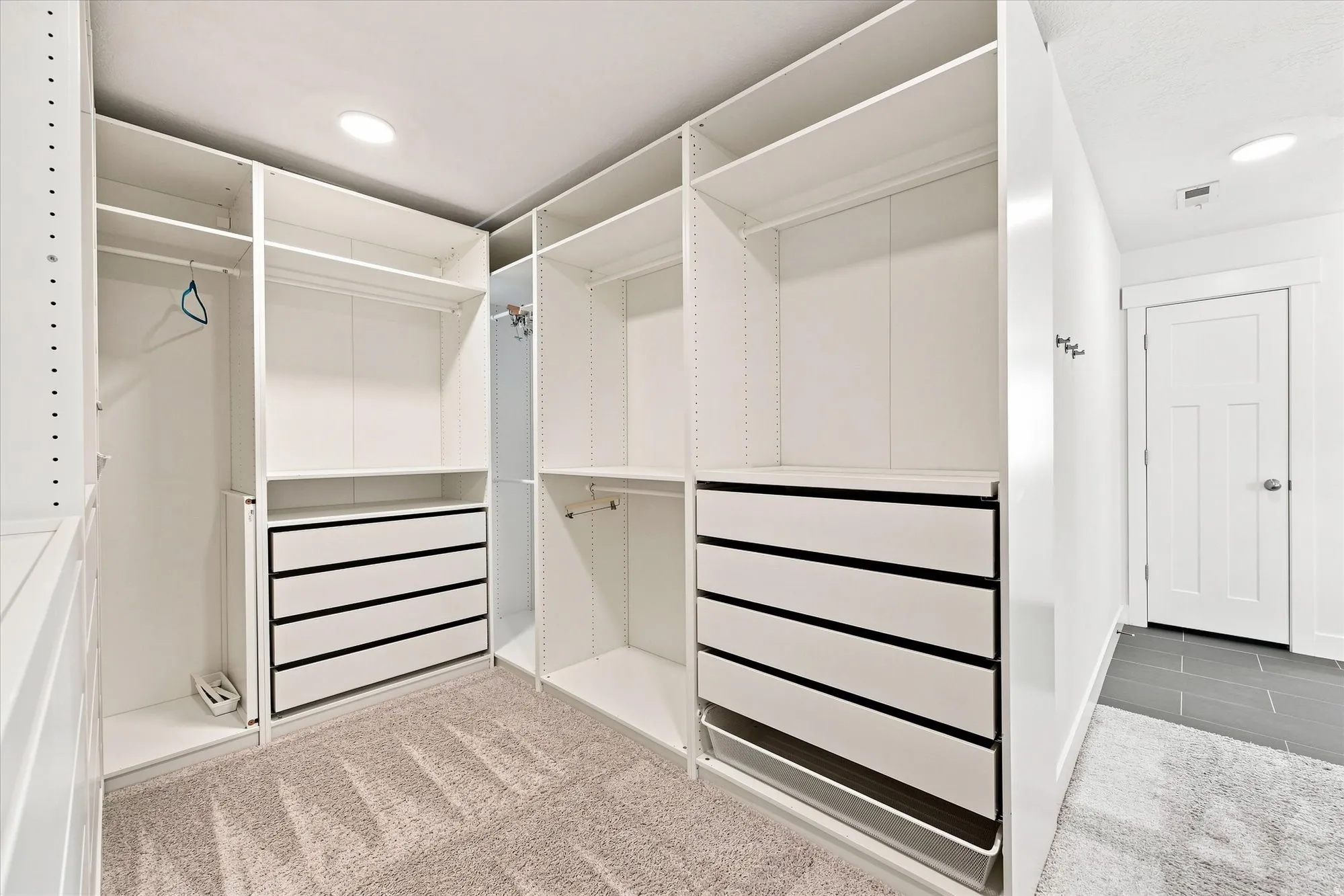 Built-in closet system with adjustable shelving, integrated drawers, and hanging rods