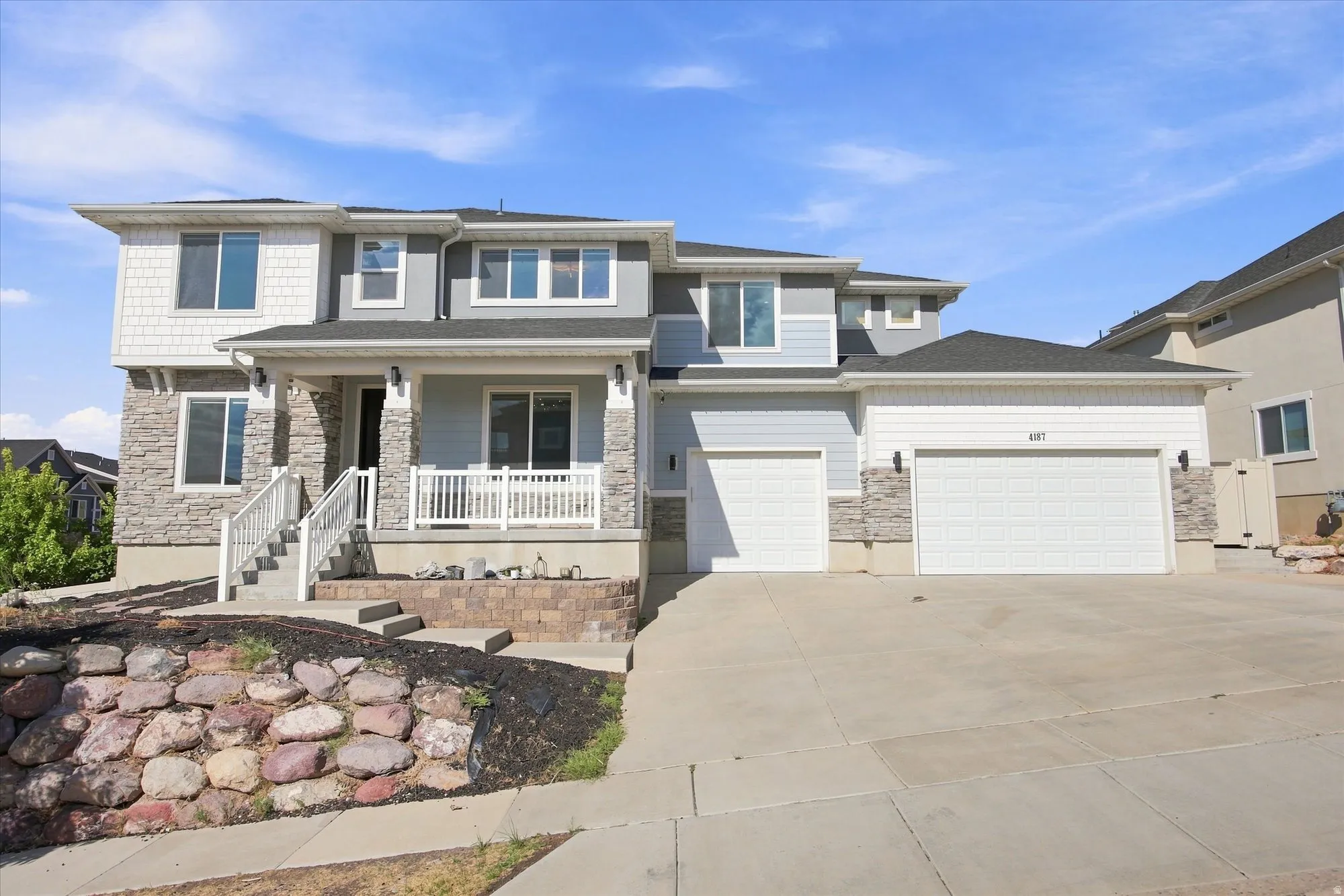 Two-story exterior with stone veneer and shingle accents