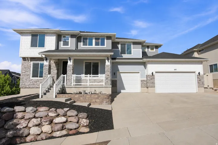 Two-story exterior with stone veneer and shingle accents