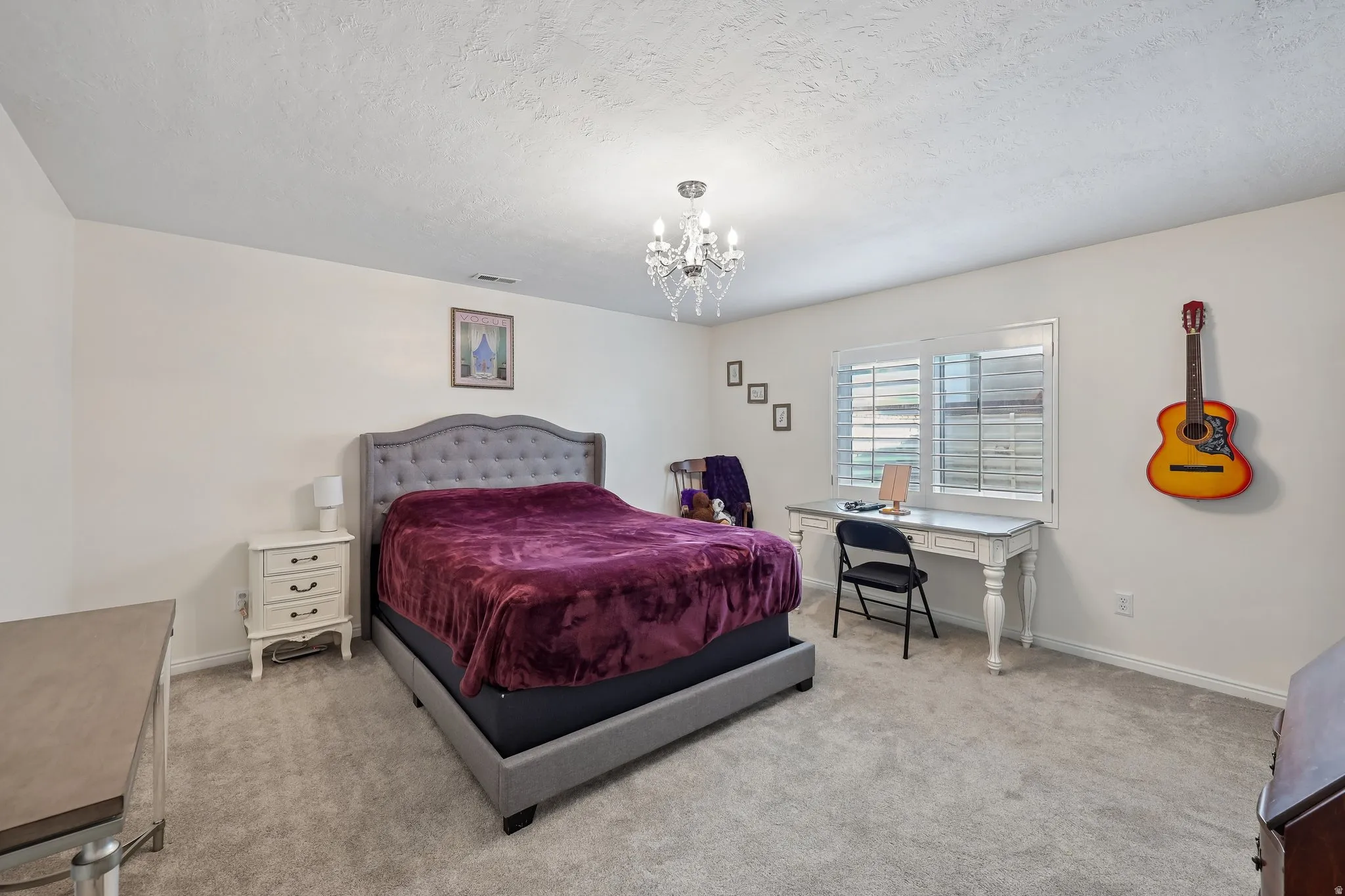 Recessed lighting, window with horizontal blinds, textured ceiling, and carpeted flooring