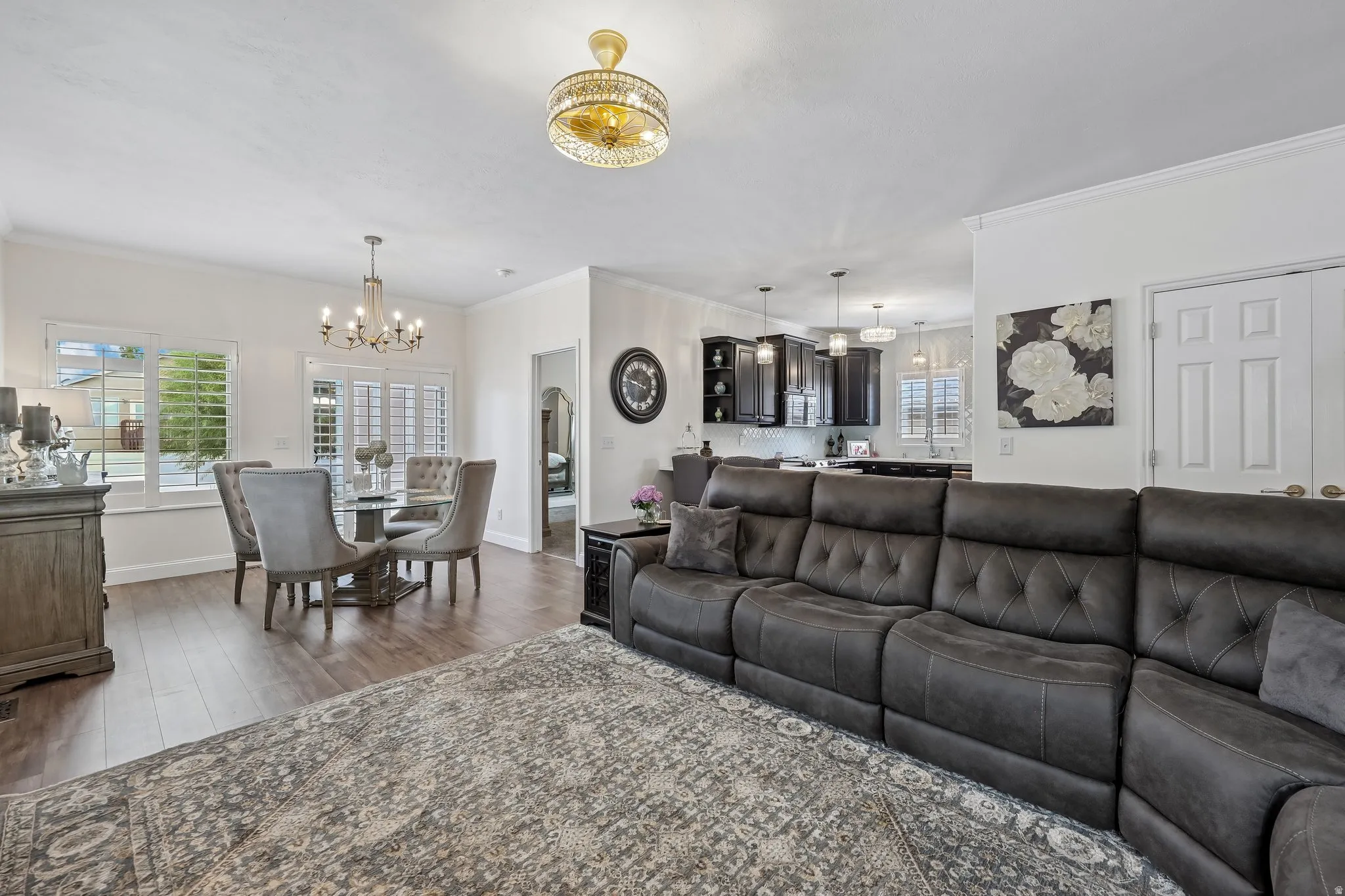 Wood-finish flooring throughout, with a dining area featuring a chandelier