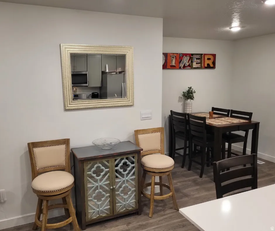 Wood-finish flooring throughout, with a recessed lighting fixture