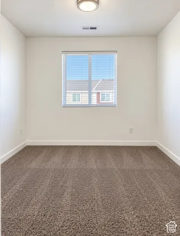 Recessed lighting, plush carpeting, window with blinds, crisp white walls, and bright overhead fixture