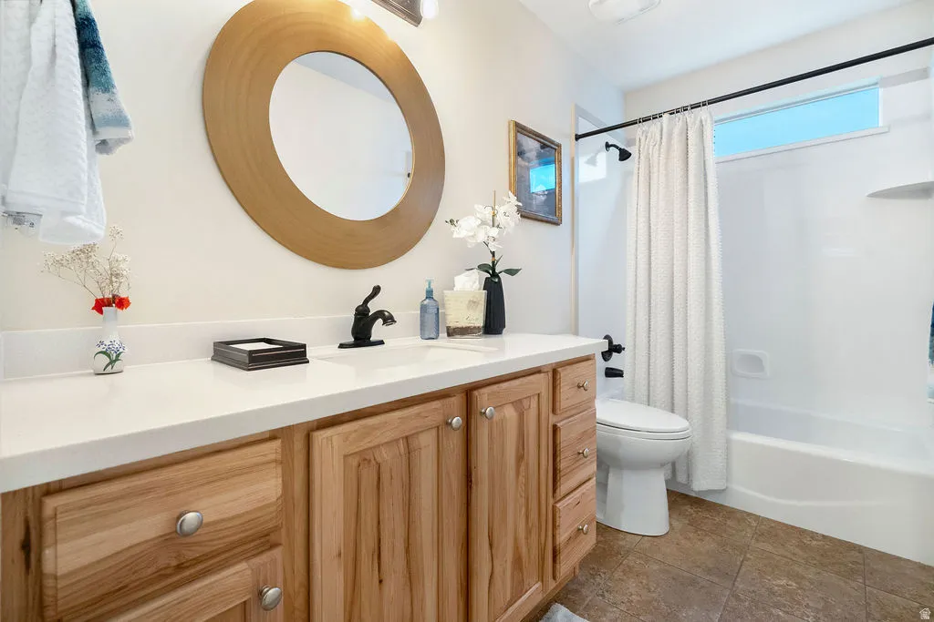 Wood-finish vanity with a white countertop and undermount sink