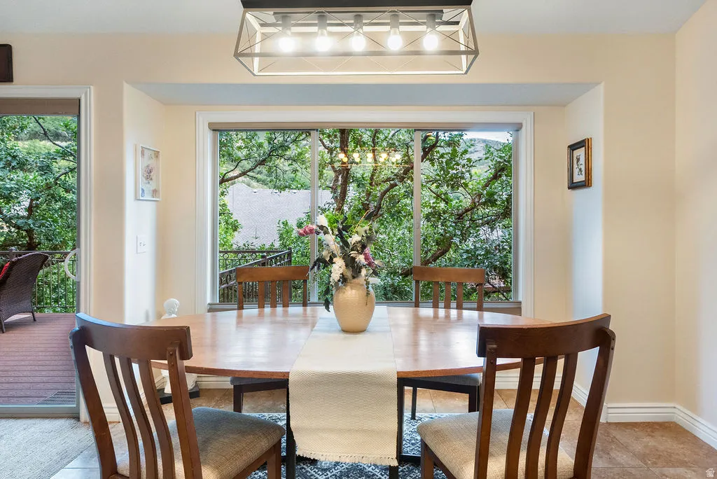 Expansive bay window, recessed lighting, tile flooring, and direct patio access