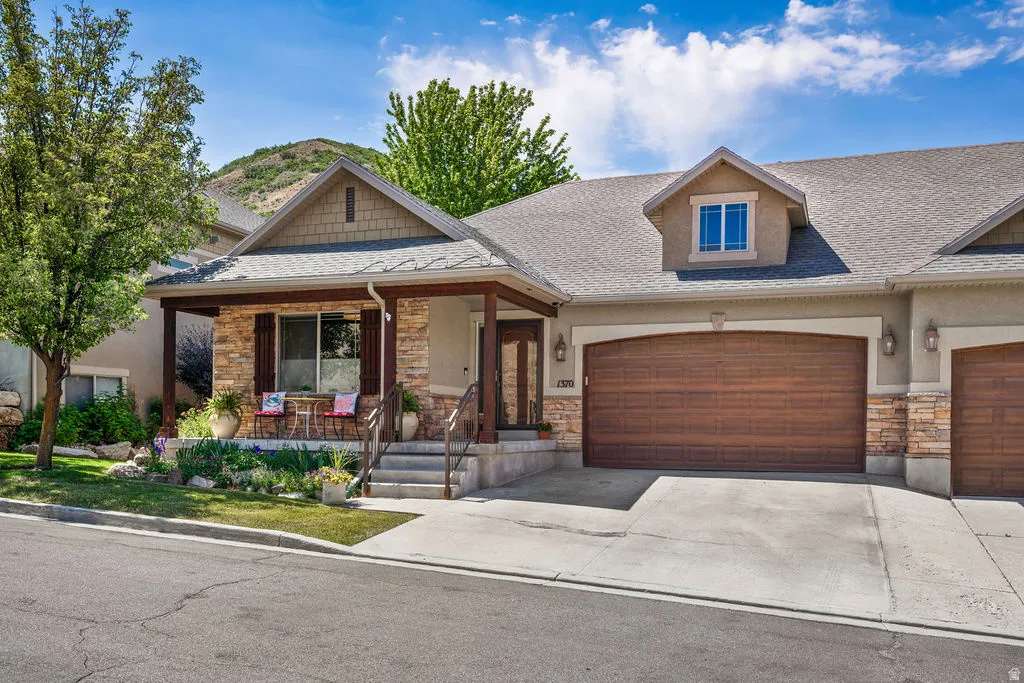 Stone and stucco exterior with a covered porch